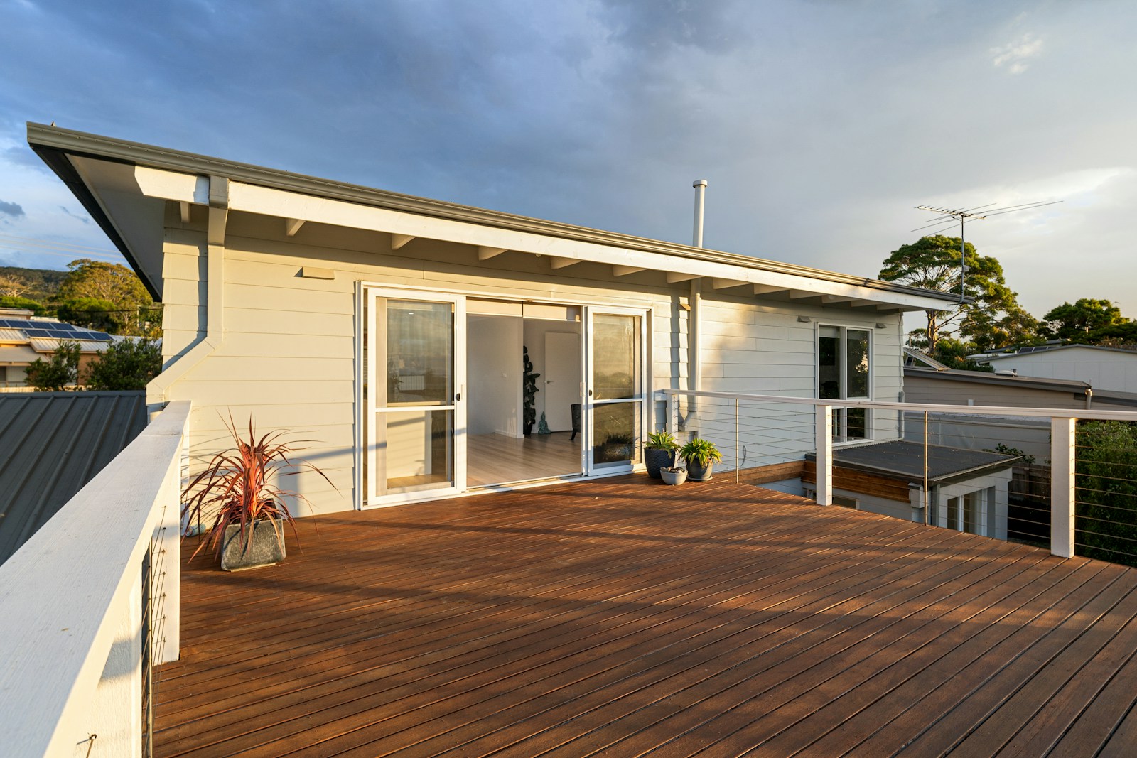 Wood deck beside a house, illustrating outdoor property improvements